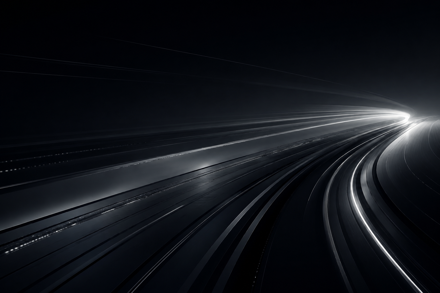 Abstract image of curved light trails on a dark background, resembling a futuristic highway or racetrack.